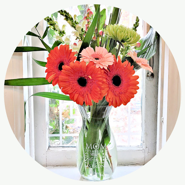 Image of Clear Glass Vase of Flowers with Anagram describing qualities found in a Mom